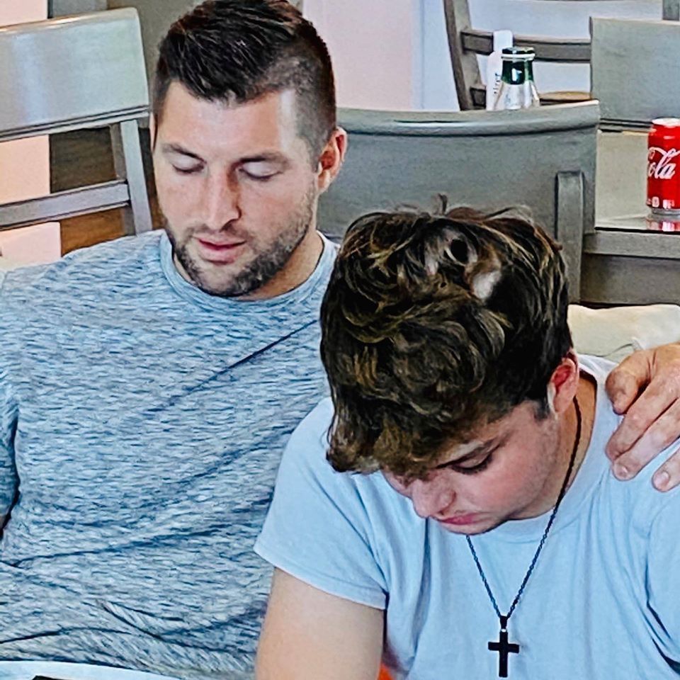 Chase sitting with Tim Tebow