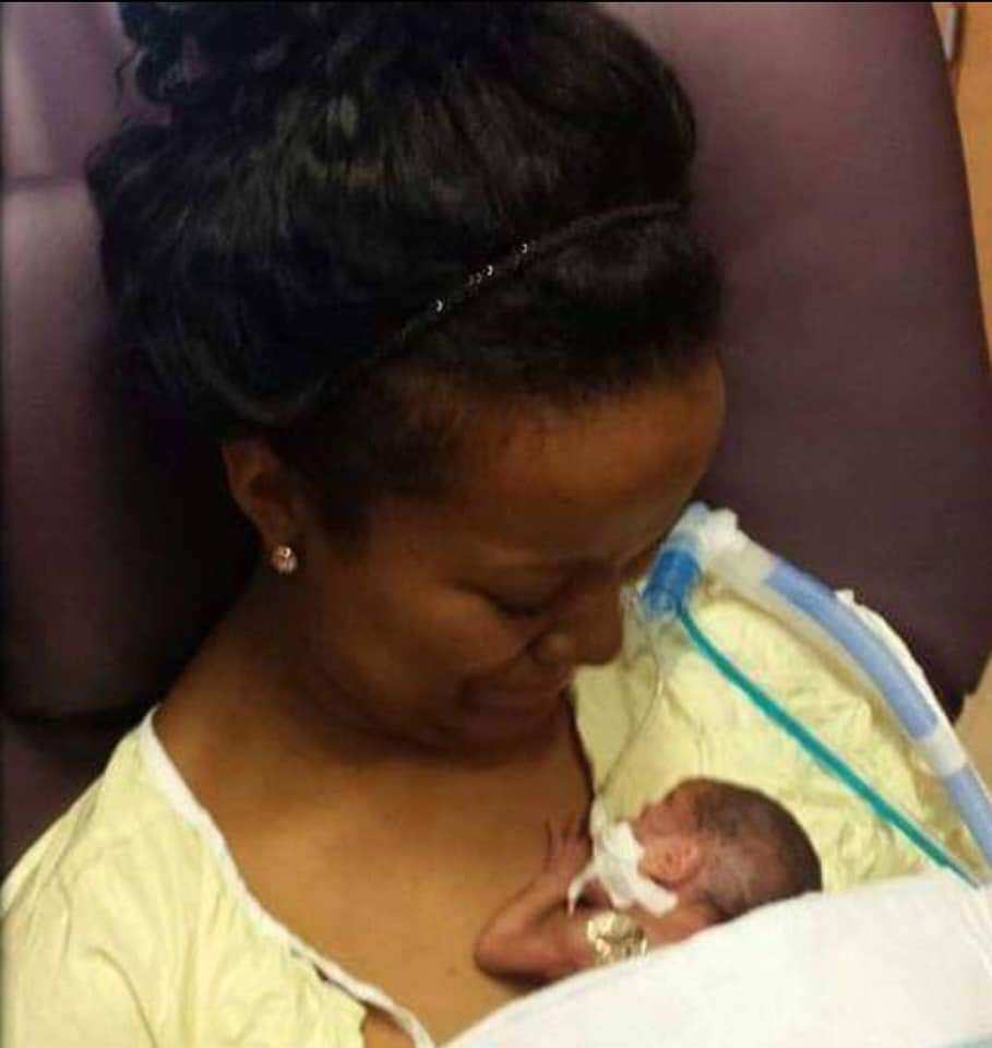Carlena Moses lays with her baby daughter, Kennedy