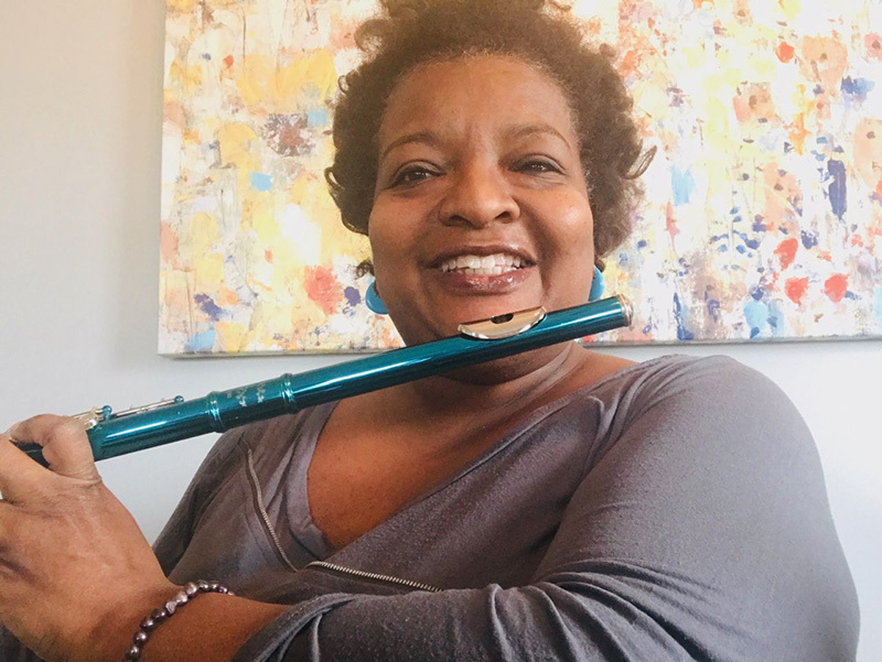 Crystal Livers-Powers smiles with her flute