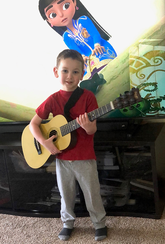 Henry plays a guitar