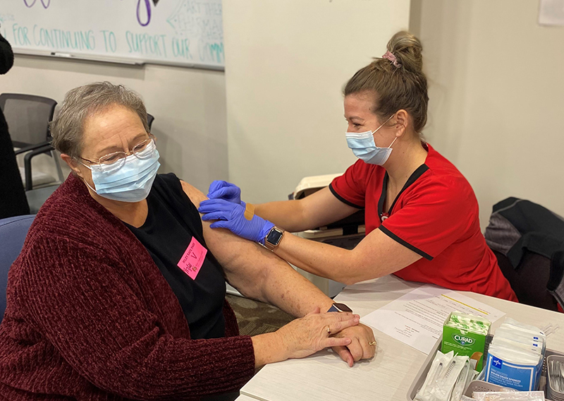 Julia Drake receives her Pfizer vaccine in her arm