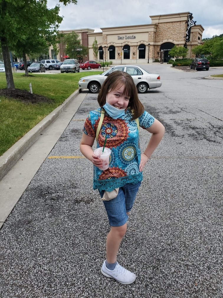 Lacey poses with a smile outside