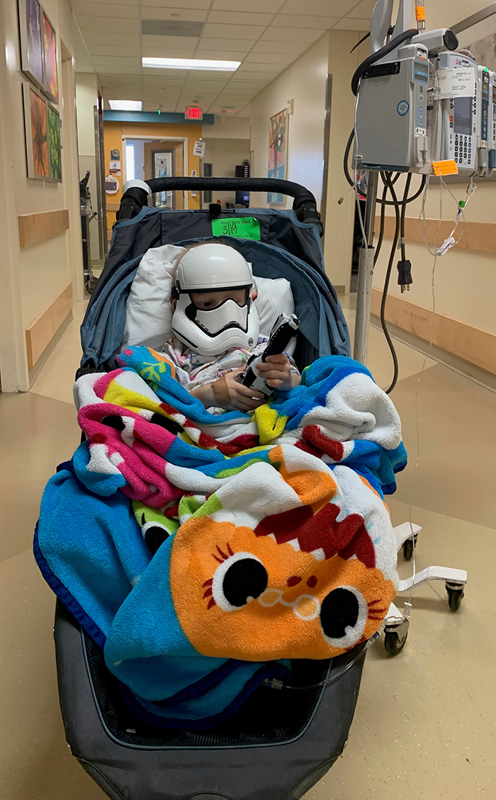 Miles wears a stormtrooper mask in the halls of Riley