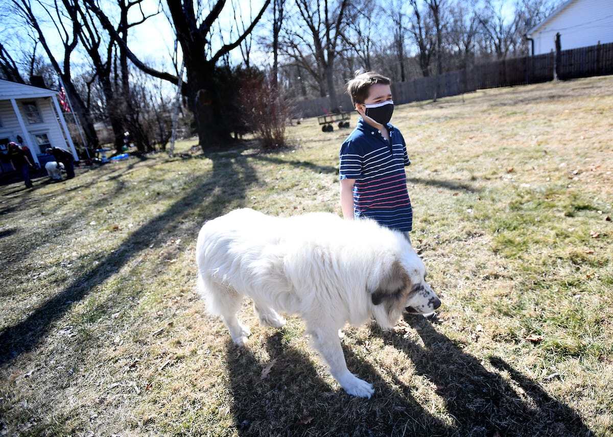 Zarrien walks his dog in their Indianapolis backyard