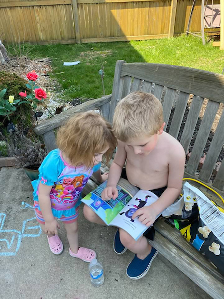 Lauren and Dustin reading a book outside