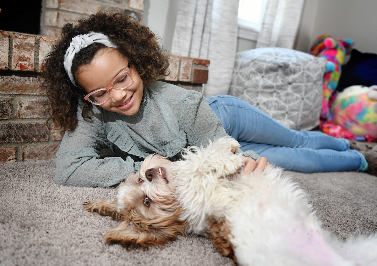 Nyla plays with her dog Ty