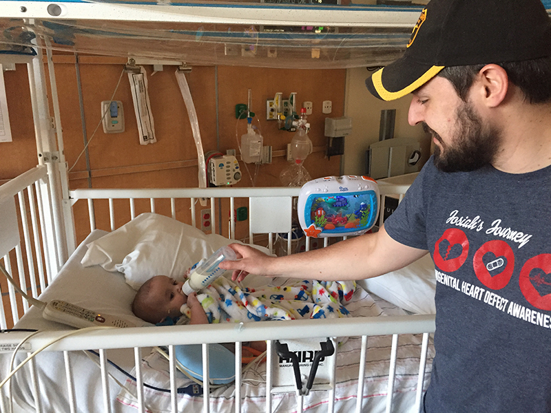 Josiah's dad feeding him a bottle