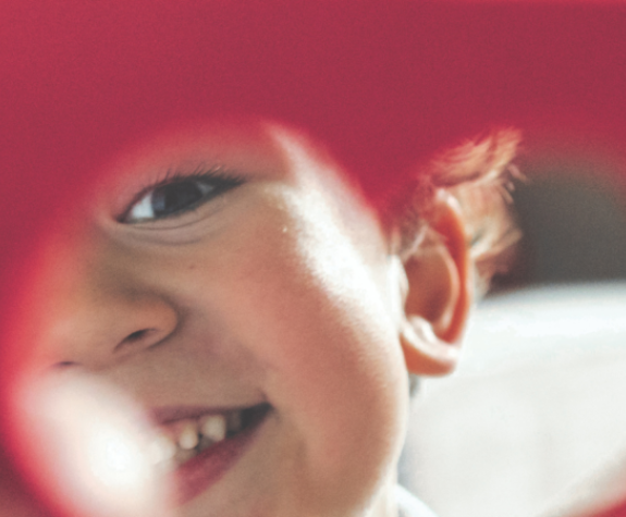 child holding paper heart