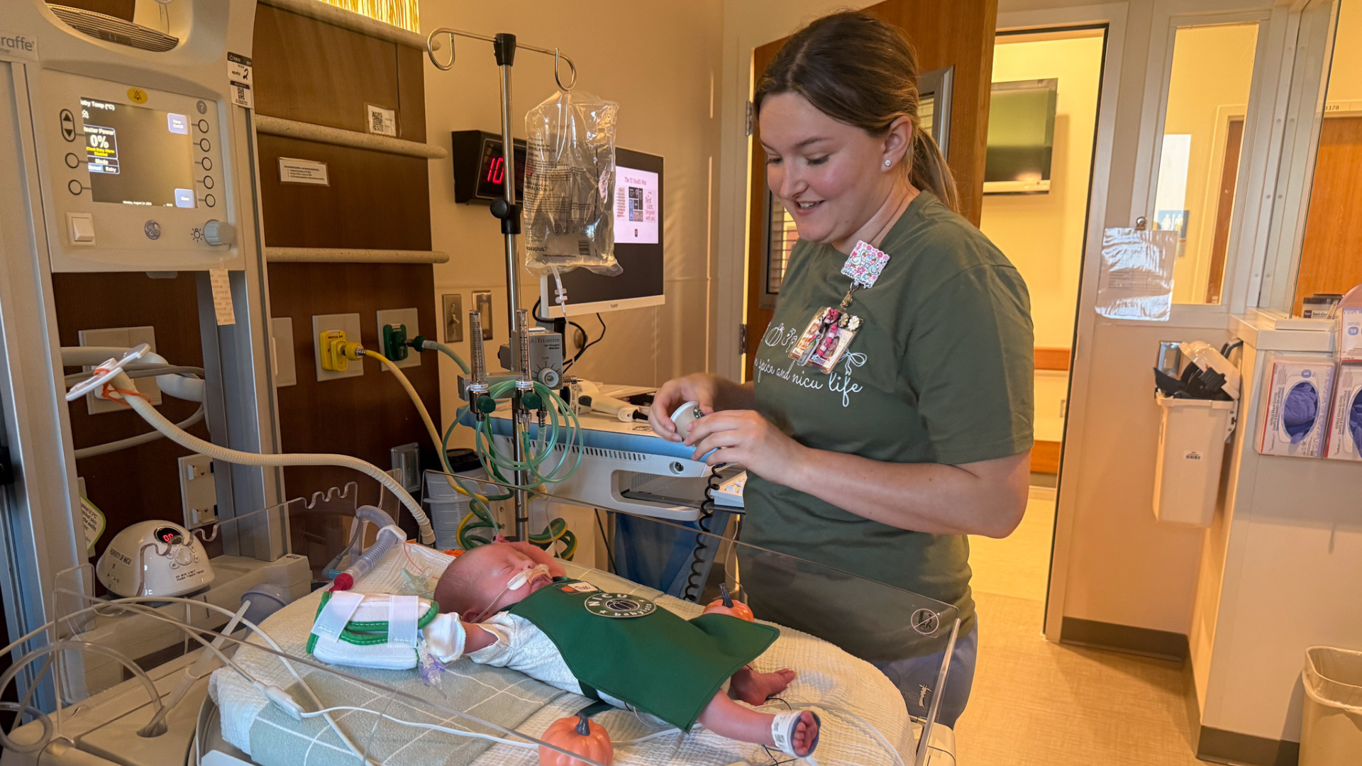 nurse dressing baby as barista