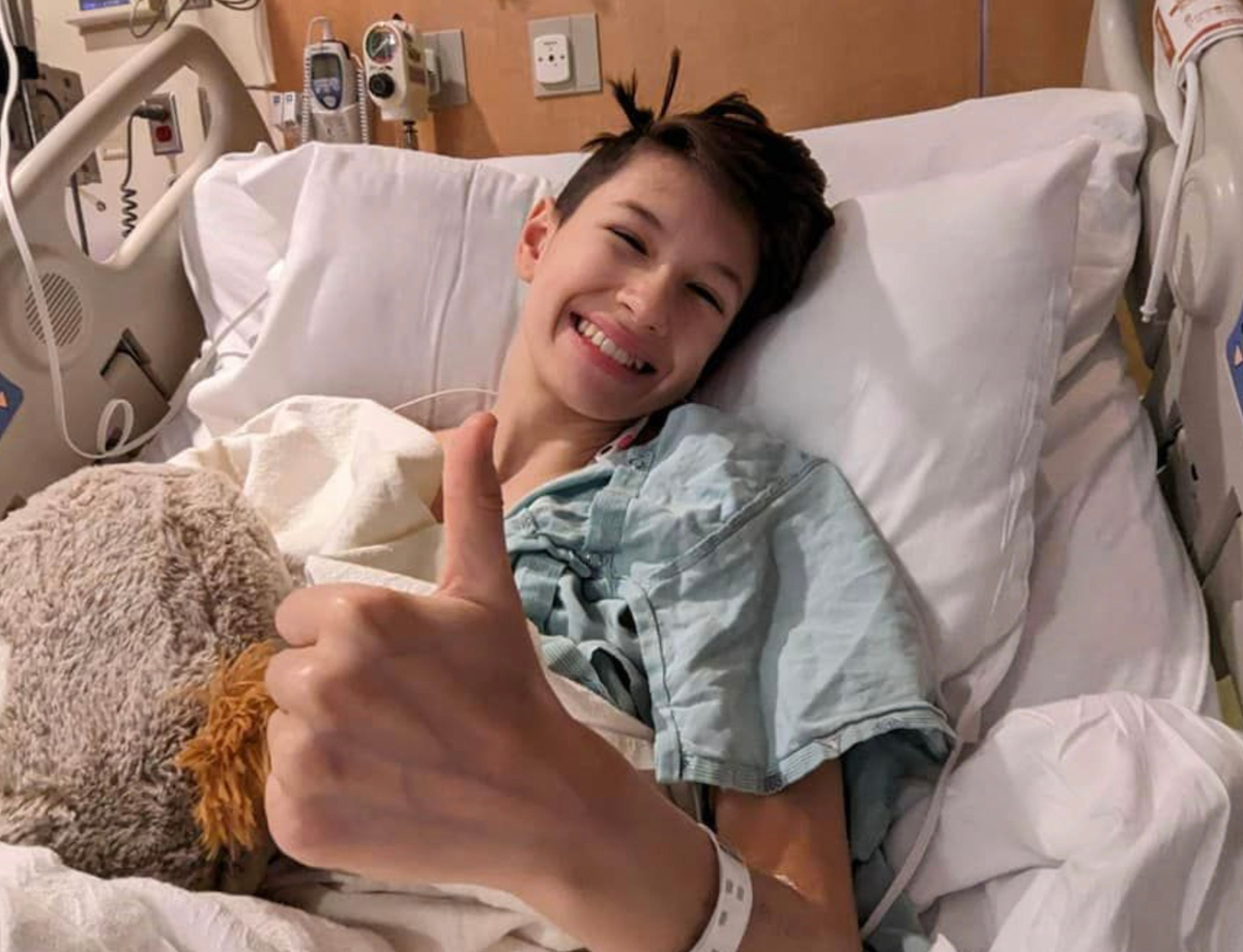 Isabela Juricevic in the hospital giving a thumbs up